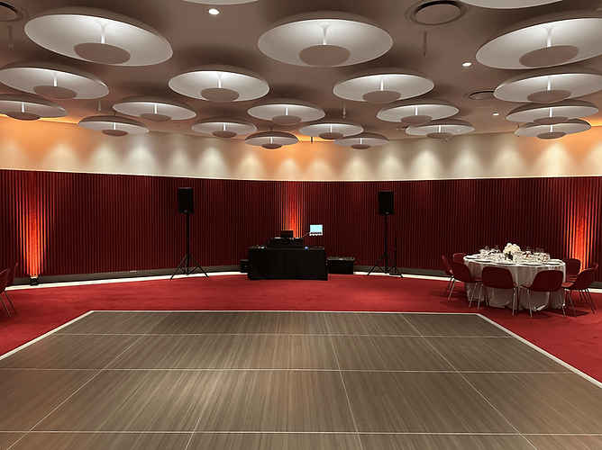 Vibrant wedding uplighting at the TWA Hotel in NYC, highlighting its retro-futuristic design.