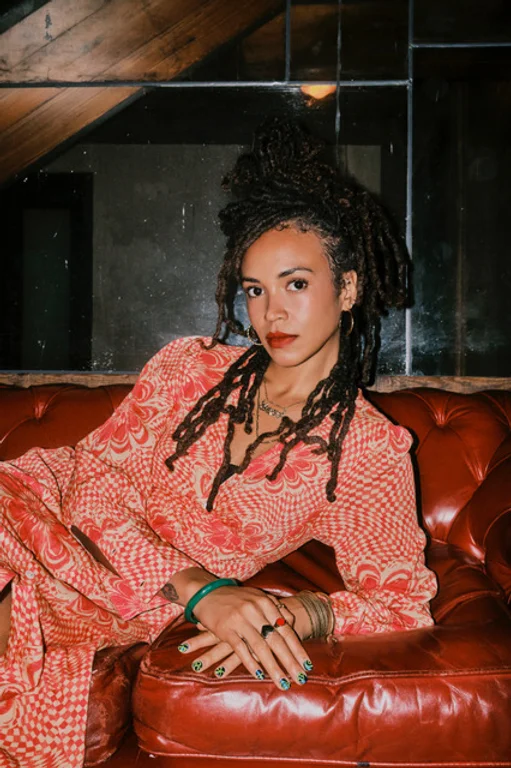 Ayanna Heaven, female wedding DJ NYC, seated portrait