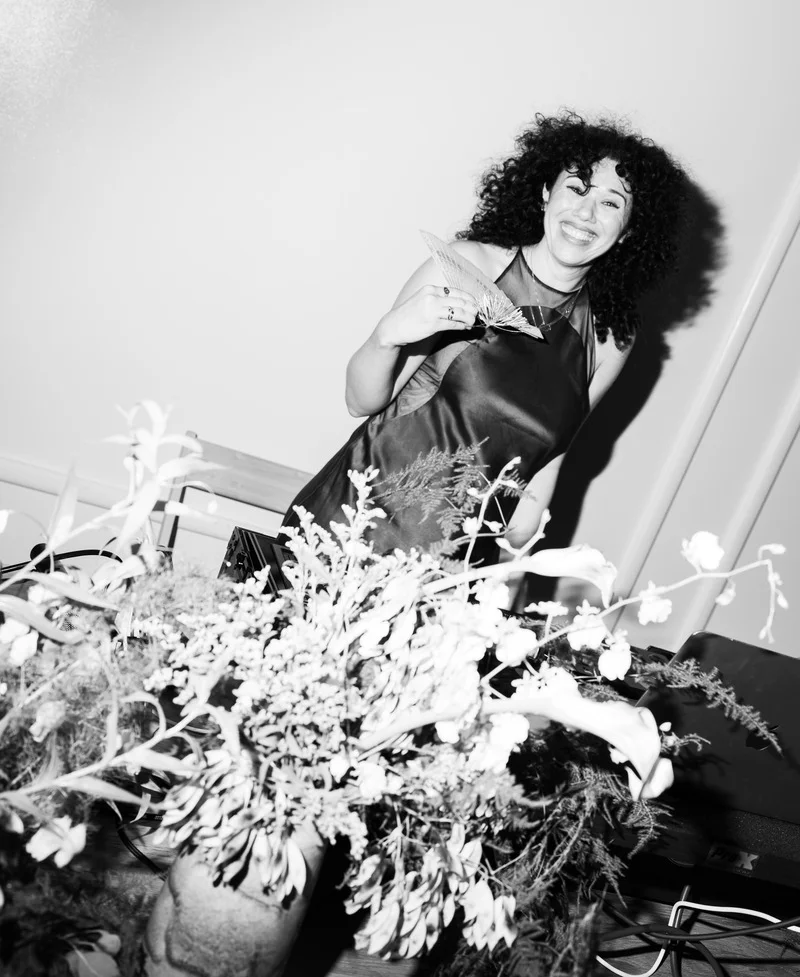 Olivia Bradley-Skill DJing a wedding, focused on her equipment while keeping the dance floor energized