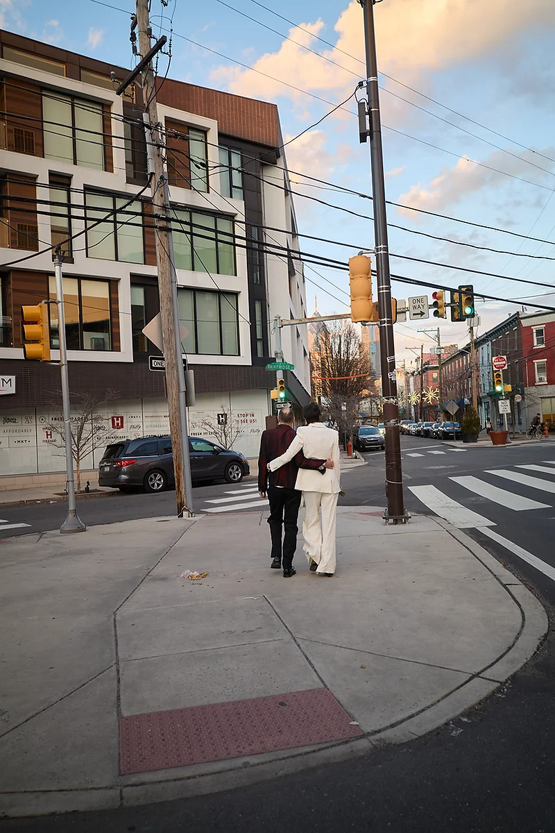 Couple walking through Philadelphia after their wedding