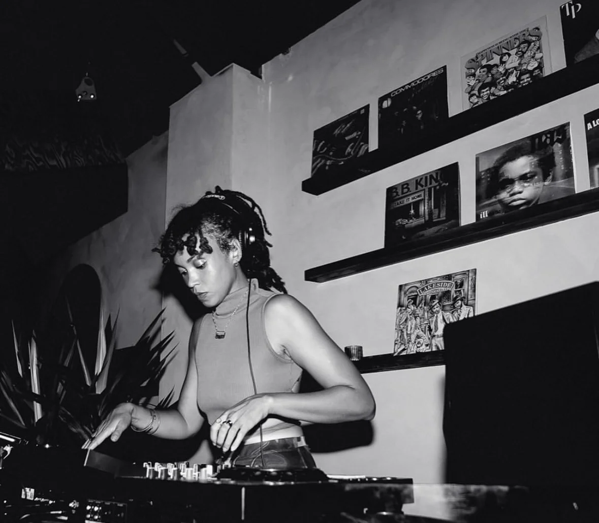 Ayanna Heaven, NYC female wedding DJ, spinning vinyl at a record bar in New York City