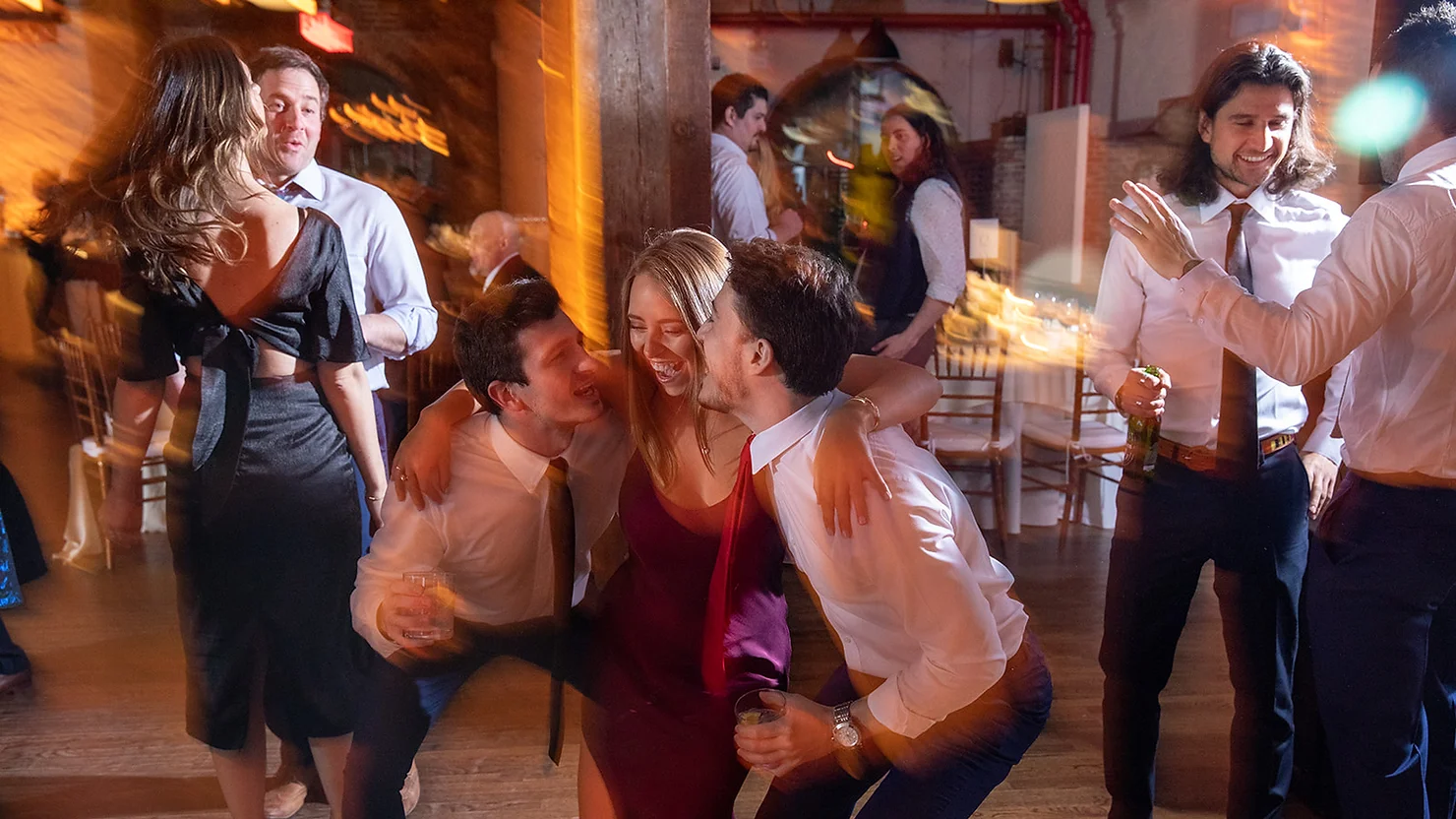 Wedding DJ for Liberty Warehouse venue. People drunkenly dancing and having fun while holding their drinks.