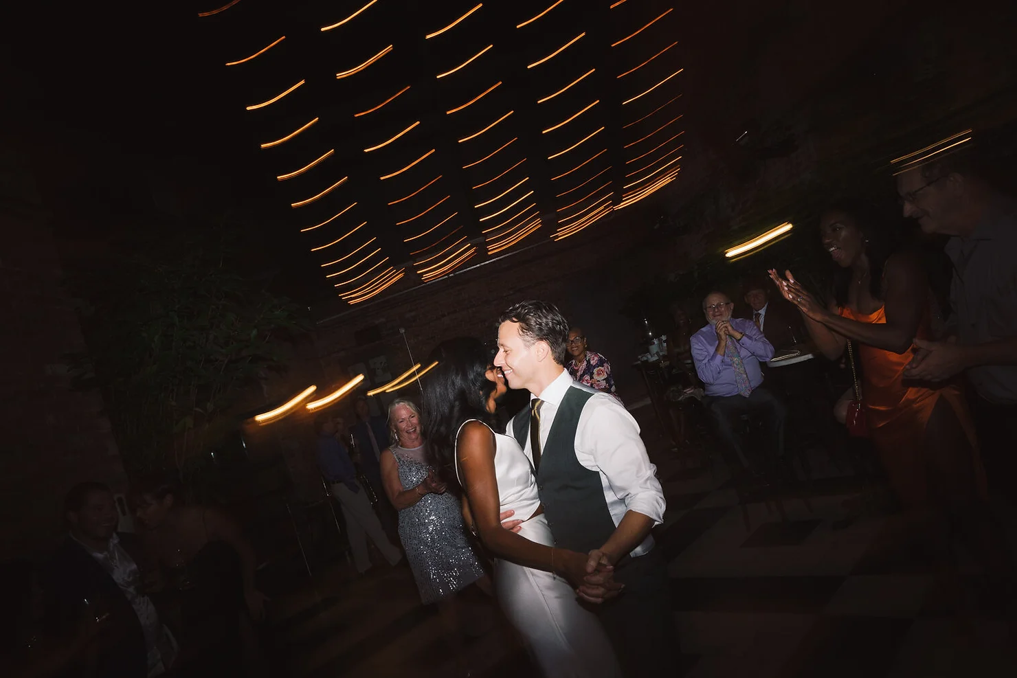 Bride and groom dancing to DJ at wedding