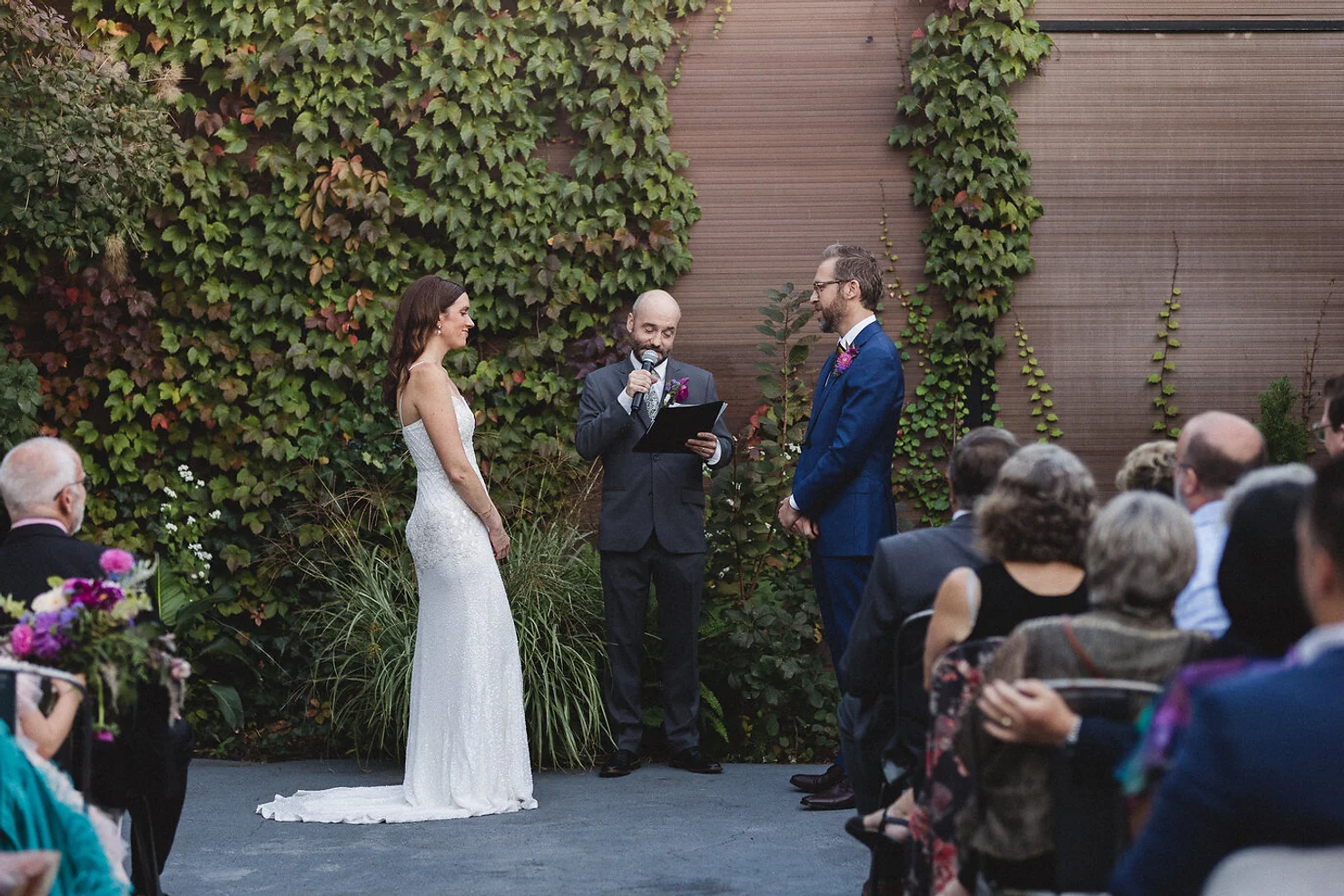 Wedding officiant with bride and groom