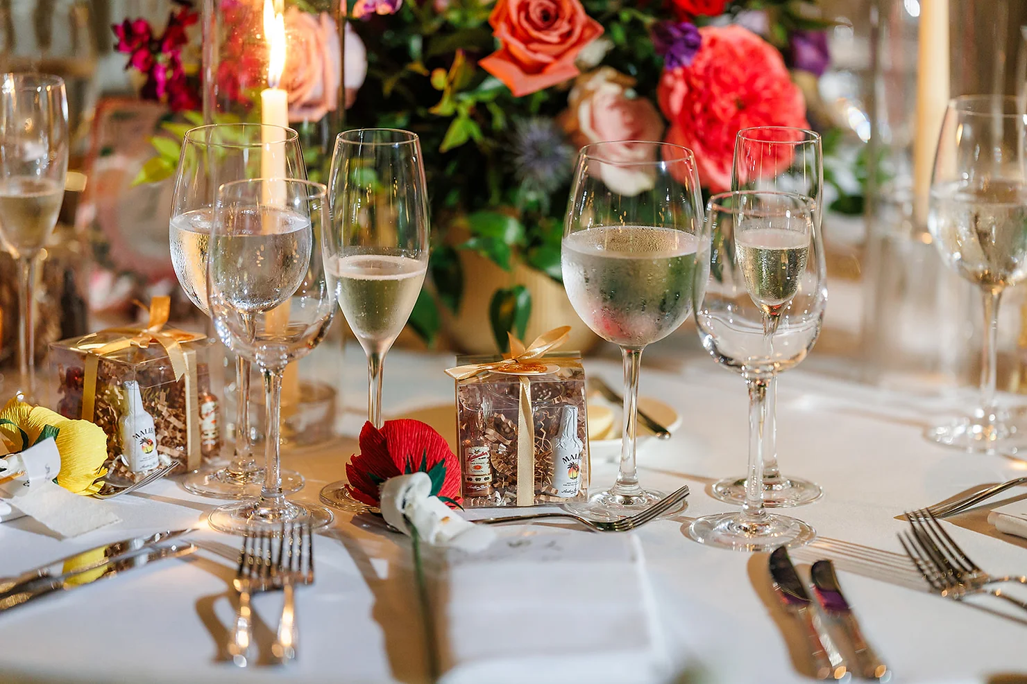 nyc Palm House at the Brooklyn Botanic Garden non traditional wedding dj Elegant wedding table with champagne flutes, candle, floral centerpiece, and gold-ribbon favor boxes.
