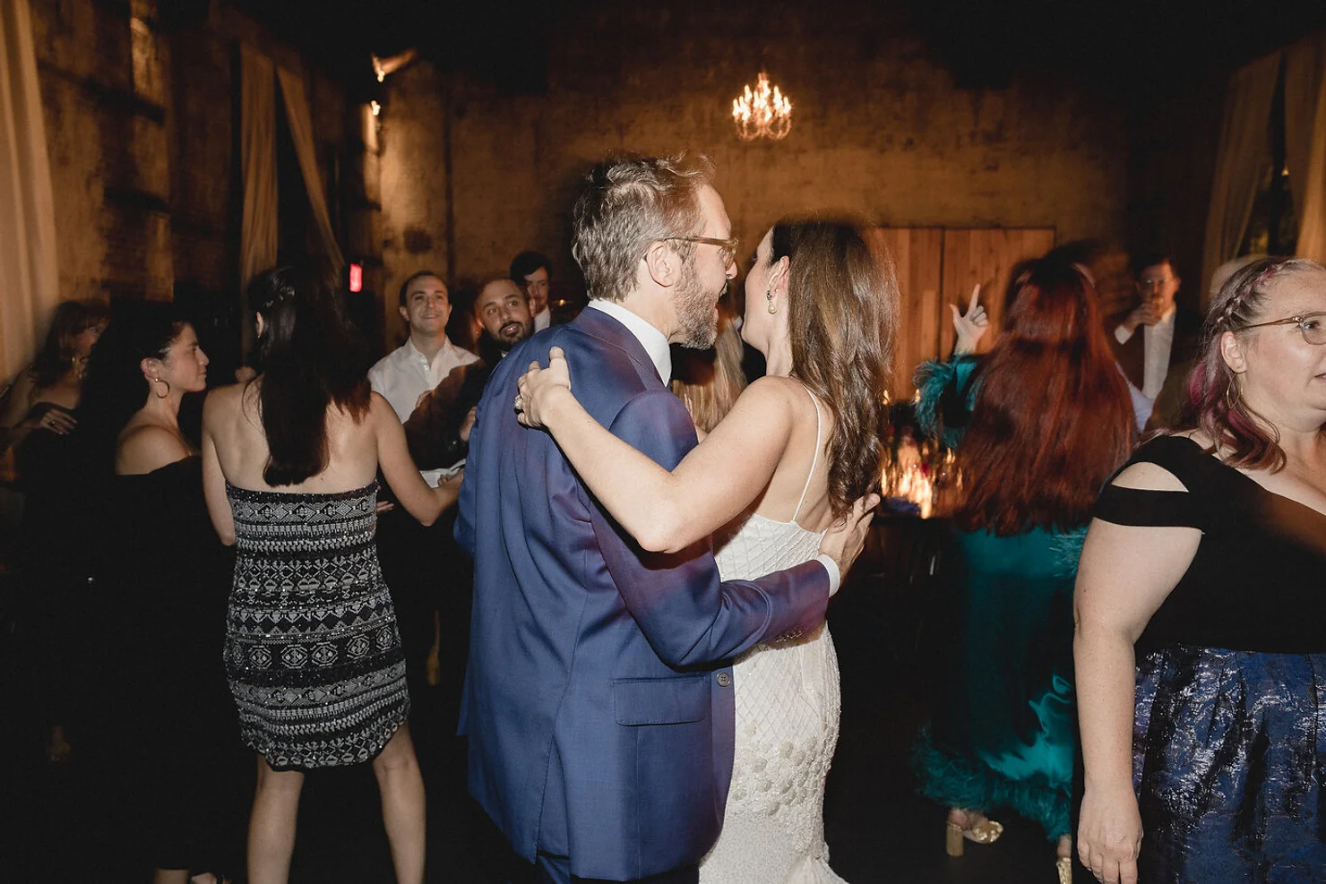 Bride and groom dancing to DJ at wedding
