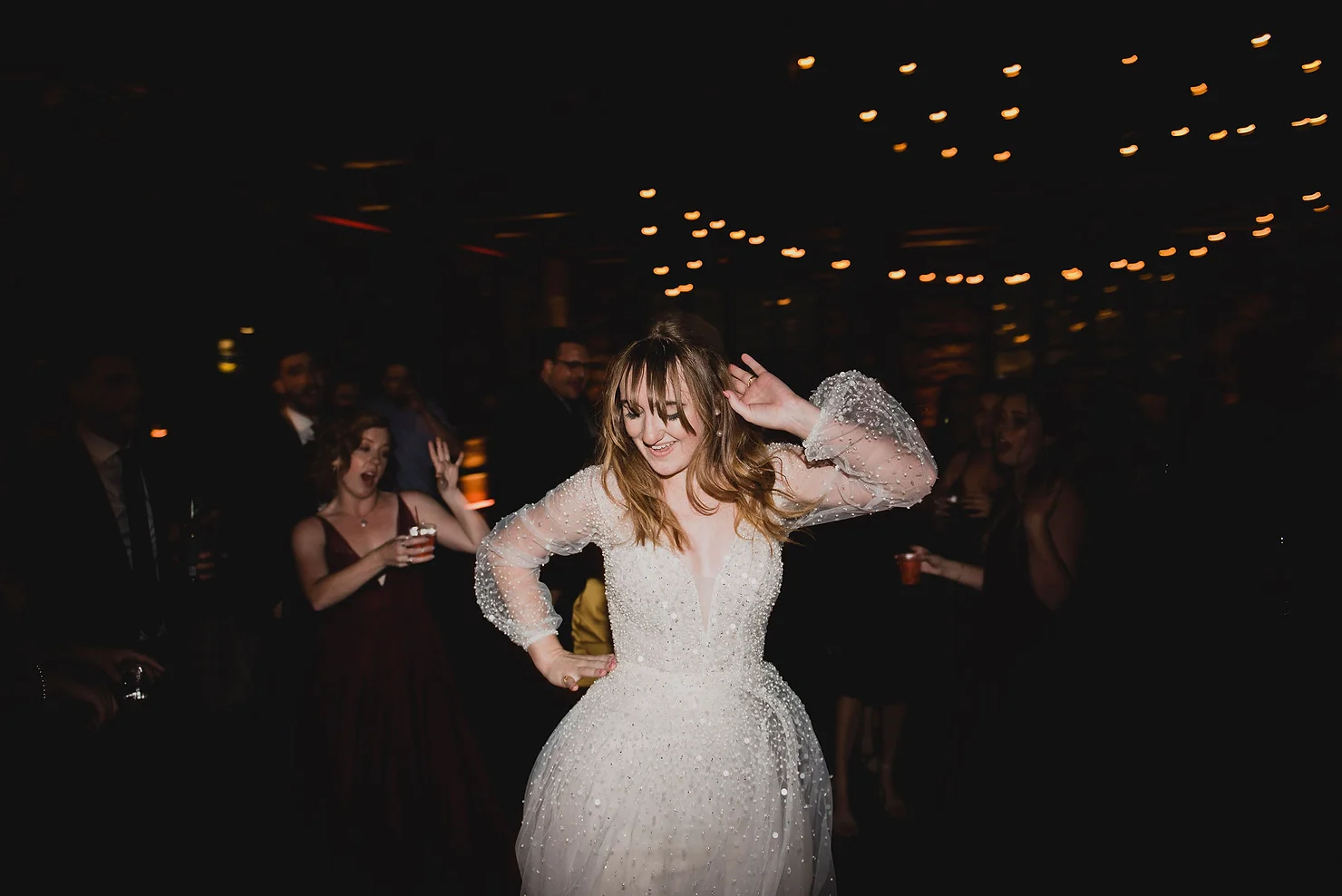 Bride dancing to DJ at wedding