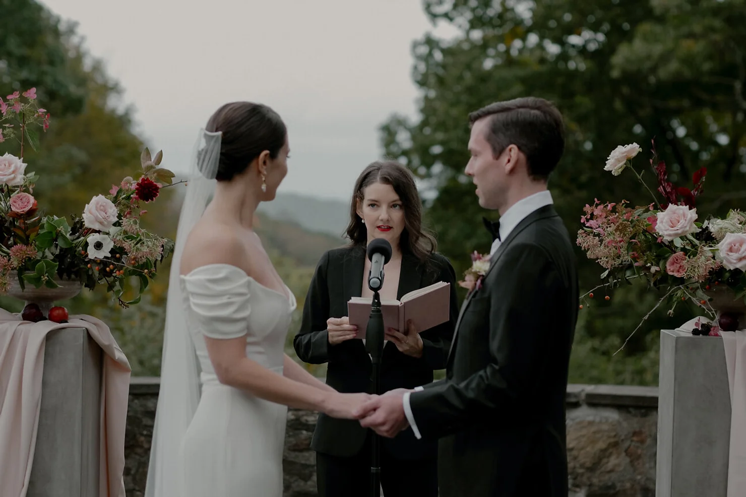 Wedding officiant with bride and groom
